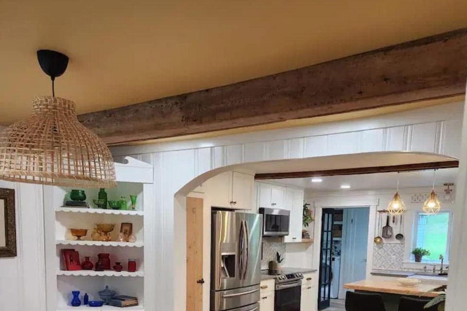 Renovated dining room with an arched opening to the kitchen